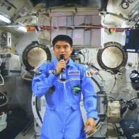 Astronaut Takuya Onishi speaks from the International Space Station during a televised news conference Tuesday night with the Japan Aerospace Exploration Agency's Tokyo office. Onishi holds first press conference from ISS, vows to work hard
