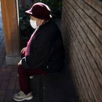 A woman sits on a bench in Tokyo's Sugamo district. Data released by the welfare ministry show that Honk Kong has surpassed Japan for the world's top spot in average life expectancy for women. Japanese women lose longevity crown to Hong Kongers