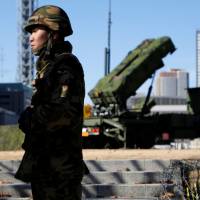 Self-Defense Forces members stand guard near Patriot Advanced Capability-3 (PAC-3) land-to-air missiles, deployed to the Defense Ministry in Tokyo, in December 2012. North Korea threat prompts Japan to upgrade Patriot batteries in time for Olympics: sources