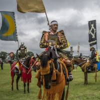 Horsemen in samurai garb participate in a ceremony during the Soma Nomaoi festival at Hibarigahara field in Minamisoma, Fukushima Prefecture, on Sunday. 43,000 flock to Minamisoma for festival's horseback samurai climax