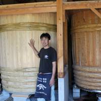 Cedar tubs: Yasuo Yamamoto stands in front of the large <em>kioke</em> (wooden barrels) that he uses to ferment his soy sauce. 'Kioke': The secret ingredient of soy sauce