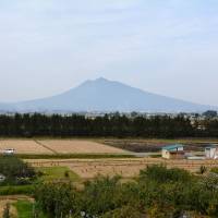 Faded backdrop: Mount Iwaki, a volcano known for its Mount Fuji-like shape, rises above the farms of Tsugaru. Wandering the 'real Japan': Following the far-north footsteps of Alan Booth