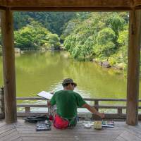 A painter in the garden at Shinshoji Temple. The eels, windmills and holy cars of Narita