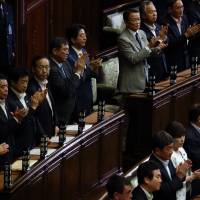 Power relations: Prime Minister Shinzo Abe and members of his predominantly male party stand during a plenary session of the Lower House at parliament in Tokyo. At present there is a bipartisan bill in the Diet that urges parties to set quotas for female candidates. However, without making these quotas mandatory, it will be almost impossible to persuade male career politicians to risk their livelihoods for the sake of a political ideal. How long can Japan's old mens' club last?