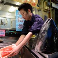 Troubled waters: A vendor displays slices of tuna at a store in Tokyo's Tsukiji market, the nation's biggest seafood-trading hub. The market is scheduled to be relocated to reclaimed land in Toyosu, Tokyo Bay, in November, but some experts are concerned about health and safety issues at the new site. Emotions run high over Tsukiji fish market's move
