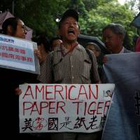 Troubled waters: A protester from a pro-China party chants slogans outside the U.S. Consulate in Hong Kong. He is against the United States supporting an international court ruling that denied China’s claims to the South China Sea. China: more hegemon than bogeyman?