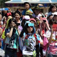 Crowds, heat and stress: People have fun — or do they? — at Tokyo Disneyland during the summer holidays. Better to holiday at home than endure a resort during the Japanese summer