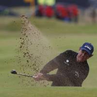 Phil Mickelson hits out of a bunker on the 18th hole during the third round of the British Open on Saturday in Troon, Scotland. Stenson takes lead away from Mickelson in third round