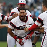White Sox outfielder Melky Cabrera celebrates with his teammates after hitting a game-winning single against the Tigers on Sunday at U.S. Cellular Field in Chicago. The White Sox won 5-4. Cabrera lifts White Sox to victory in ninth