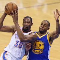 Superstar Kevin Durant (left) announced Monday that he will play for the Golden State Warriors next season. Durant rocks NBA in move to Warriors