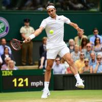 Roger Federer plays a shot from American Steve Johnson during their fourth-round match at Wimbledon on Monday. Federer won 6-2, 6-3, 7-5. Federer, Murray, Serena advance to quarterfinals