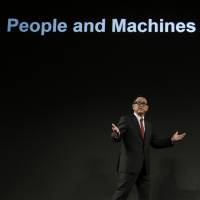 Akio Toyoda, president of Toyota Motor Corp., speaks during a news conference in Tokyo in November 2015 to announce the launch of the automaker's artificial intelligence research and development unit. Government to back AI technology development in medical, production sectors