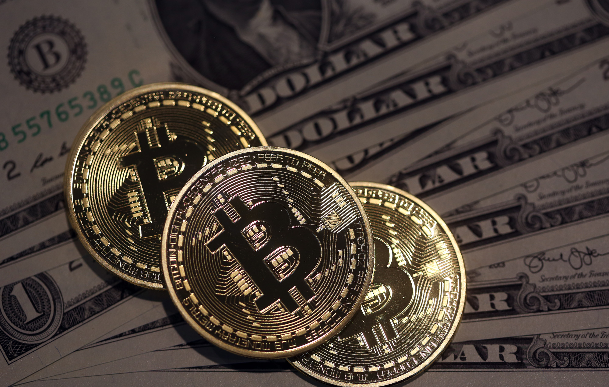 Bitcoin sinks after hackers steal $65 million from ...