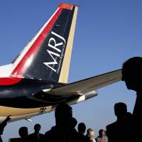 The tail of a Mitsubishi Regional Jet is shown in 2014. Mitsubishi Aircraft Corp. aborted test flights to the United States on Saturday and Sunday due to problems with the MRJ's air-conditioning system. MRJ back in hangar after test flights to U.S. thwarted by air conditioner