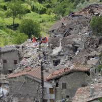 Rescuers search through debris of houses in Pescara del Tronto, Italy, on Wednesday following a magnitude-6.2 earthquake. Italian quake toll nears 250 as rescuers struggle to find survivors