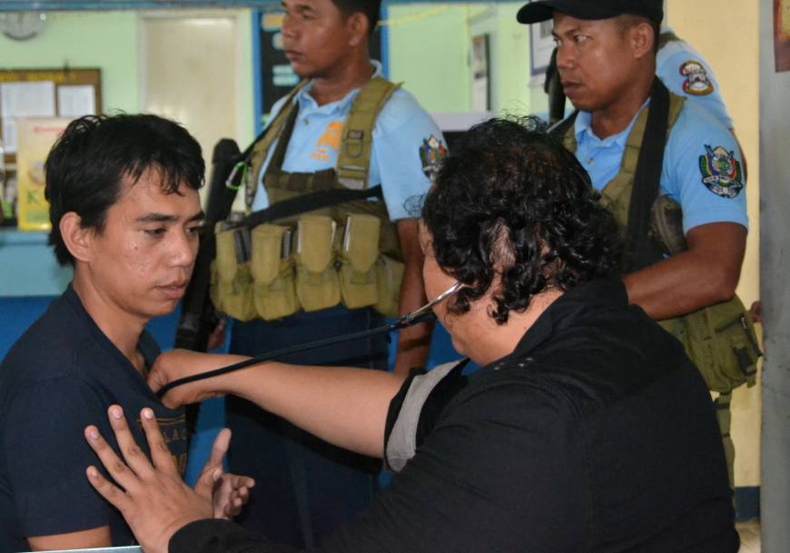 A government doctor checks Indonesian hostage Mohammad Safyan after he escaped from Abu Sayyaf captors, in Jolo, Sulu, in southern Philippines Wednesday.