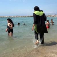 A bather wears a burqini in Marseille, France, on Aug. 4. Beach clashes lead to third French burqini ban