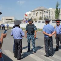 Kyrgyz police gather outside the Chinese embassy in Bishkek on Tuesdday. A van driven by a suicide bomber exploded after ramming through a gate at the embassy, wounding three people, authorities said. Car bomber dies, at least three hurt in attack on Chinese Embassy in Kyrgyzstan