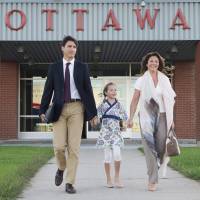 Canadian Prime Minister Justin Trudeau, his wife, Sophie Gregoire, and daughter, Ella-Grace, walk to board a government plane in Ottawa, Ontario, on Monday. Trudeau left for his first official visit to China. Chinese talk show host accuses Canadian tourism body of censoring discussion about Aboriginals on travel program