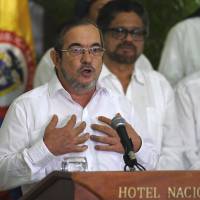 Timoleon Jimenez, head of Colombia's FARC leftist guerrilla movement, speaks during a news conference with other delegation members in Havana on Sunday. The rebel force ordered a definitive cease-fire as part of an accord to end 52 years of conflict with the government. Colombia rebel leader Jimenez orders cease-fire to end half-century-long armed conflict