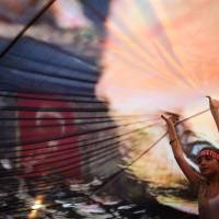 A Turkish girl helps to hold up a huge picture of modern Turkey's founder Mustafa Kemal Ataturk at a rally in Gundogdu Square in Izmir on Thursday. Ankara issues warrant for U.S.-based preacher Gulen over failed coup