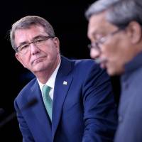 U.S. Secretary of Defense Ash Carter and Indian Defense Minister Manohar Parrikar attend a news conference at the Pentagon on Monday in Washington. In key step toward stronger defense ties, U.S., India ink military logistics agreement