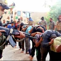This image posted online by Islamic State militants on June 14, 2014, shows Iraqi cadets captured by Islamic State moments before they were killed in Tikrit, Iraq. Iraqi officials say the country has executed 36 men on Sunday convicted of taking part in the Islamic State group's massacre of hundreds of soldiers in 2014. 36 Islamic State ranks go to gallows over 2014 murder of 1,700 Iraqi military recruits