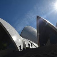 Visitors walk around the outside of the Sydney Opera House on Thursday. Sydney Opera House to get an acoustic upgrade
