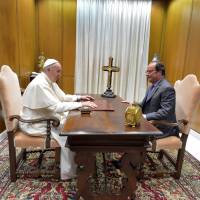 Pope Francis talks with French President Francois Hollande at the Vatican Wednesday. Hollande meets pope after priest's slaying, to 'discuss religious freedom'