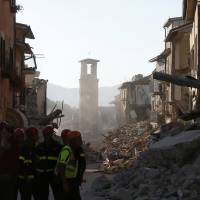 Firefighters work Saturday along the earthquake-damaged main street in Amatrice, Italy, on Saturday. Shoddy home renovations may have contributed to Italy quake toll