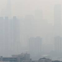 The Singapore skyline is hardly visible Friday due to haze. Smog and a strong acrid smell blanketed Singapore as smoke from forest fires in Indonesia blew into the city-state. Singapore shrouded by blanket of smog as illegal forest fires burn in Indonesia