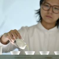 Xie Yu-tung, founder of the ultramodern tea shop Xie Xie, demonstrates her skills in Taipei on July 21. Taiwan's tea entrepreneurs brew up new twists on tradition