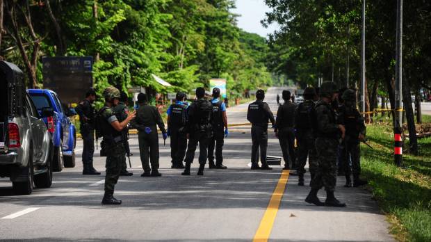 Thai soldiers watch as a forensics unit inspects the scene of an attack following two roadside bomb blasts at four separate locations by suspected separatist militants in the Bacho district of Thailand's restive southern province of Narathiwat on Monday. Fresh explosions rocked Thailand's deep south, seriously wounding one soldier on Monday, days after a spate of bomb and arson attacks struck multiple tourist resort towns. Cellphone find leads Thai cops to seek Malaysia cooperation in fatal resort bombings