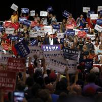 Republican U.S. presidential candidate Donald Trump speaks at a rally in Dimondale, Michigan, on Friday. Staff revamp over, Trump campaign refocuses on Clinton, policies