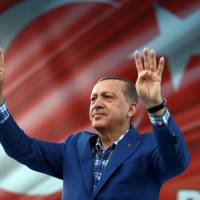 Turkish President Recep Tayyip Erdogan addresses a rally in Gaziantep, Turkey, Sunday. Erdogan said a 14 year-old suicide bomber was responsible for last weekend's explosion in Gaziantep that claimed dozens of lives. Turkey forces push farther into Syria, pound U.S.-backed Kurdish forces; at least 35 civilians killed