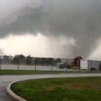 This image made from a video shows a tornado Wednesday in Kokomo, Indiana. Multiple tornadoes touched down in central Indiana on Wednesday, tearing the roofs off apartment buildings, sending air conditioners falling onto parked cars and cutting power to thousands of people. Central Indiana twisters wreak havoc, flatten homes, Starbucks cafe