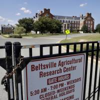 The Beltsville Agricultural Research Center, the Agriculture Department's agricultural research center and library, is seen from a locked gate after employees were informed of a threat in the morning and sent home Tuesday in Beltsville, Maryland. The Agriculture Department closed offices in five states after receiving anonymous threats. USDA spokesman Matthew Herrick said the department had received several anonymous messages that raised concerns about the safety of USDA personnel and facilities. Emailed threats to USDA workers prompt Agriculture Department offices in five states to close