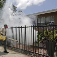A Miami-Dade County mosquito control worker sprays around a home in the Wynwood area of Miami on Monday. The CDC has issued a new advisory that says pregnant women should not travel to the Zika-stricken part of Miami, and pregnant women who live there should take steps to prevent mosquito bites and sexual spread of the virus. CDC warns pregnant women to avoid Zika-hit parts of Miami, readies response team