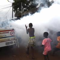 A team from the National Institute of Public Health sprays anti-mosquito product through the Koumassi district of Abidjan as children run behind their car on Wednesday during an operation aimed at preventing the spread of the Zika virus. Study finds Zika infection may harm adult brain; Miami outbreak spreads