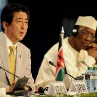 Prime Minister Shinzo Abe delivers his closing remarks as Chad's president, Idriss Deby, looks on at the end of the sixth Tokyo International Conference on African Development in Nairobi on Sunday. As Japan struggles to make inroads in Africa in face of Chinese presence, Abe pushes quality