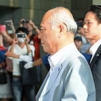 Yoichi Masuzoe enters the Tokyo Metropolitan Government building in June before resigning as governor over a money scandal. Masuzoe pays up for abusing official metro car while Tokyo governor