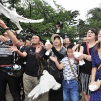 Visitors to Yasukuni Shrine in Tokyo release doves in a gesture of peace Monday as Japan marked the 71st anniversary of its surrender in World War II. Anniversary of Japan's surrender brings mix of opinions to Tokyo's sites for the war dead