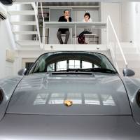 Class or crass?: Koichi Kimura and his wife sit overlooking Koichi's Porsche 911 in the dining room of their house in Higashiosaka. The building was designed so that the car could be viewed from all rooms in the house. Japan's super-rich: fun to envy, difficult to emulate