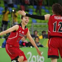 Mika Kurihara (left) and Asami Yoshida celebrate after Japan's win over Belarus in the Olympic women's basketball tournament on Saturday in Rio de Janeiro. Japan uses defensive effort to beat Belarus