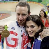 Gold medalist Bradley Wiggins of Britain poses with his wife Catherine after winning the men's team pursuit final at the Rio Olympic Velodrome during the Rio Olympics in Rio de Janeiro on Friday. Britain's most decorated Olympian contemplates what's next