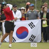 Inbee Park watches her tee shot on the 15th hole during the final round of the Olympic tournament on Saturday. Park grabs gold as Nomura just misses medal