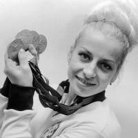 Gymnast Vera Caslavska holds her four Olympic medals, three gold and one silver, in an October 1986 file photo. Gymnastics great Caslavska dies at 74