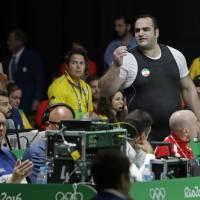 Iran's Behdad Salimikordasiabi argues a judgement that went against him during the men's over-105 kg weightlifting event at the 2016 Summer Olympics in Rio de Janeiro on Tuesday. All three of Salimikordasiabi's attempts in the clean and jerk were unsuccessful. International Weightlifting Federation website hacked after Iranian's controversial Olympic exit