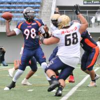 New Nojima Sagamihara starting quarterback Devin Gardner throws a pass as Obic defensive lineman Takuya Seike rushes during the first quarter of Sunday's X League game at Fujitsu Stadium Kawasaki. Gardner shines in debut but fails to lead Rise to win