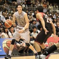 George Washington guard Yuta Watanabe dribbles against the Japan men's national team on Aug. 16 at Ryogoku Kokugikan. Colonials expect Tokyo trip to be springboard for Watanabe